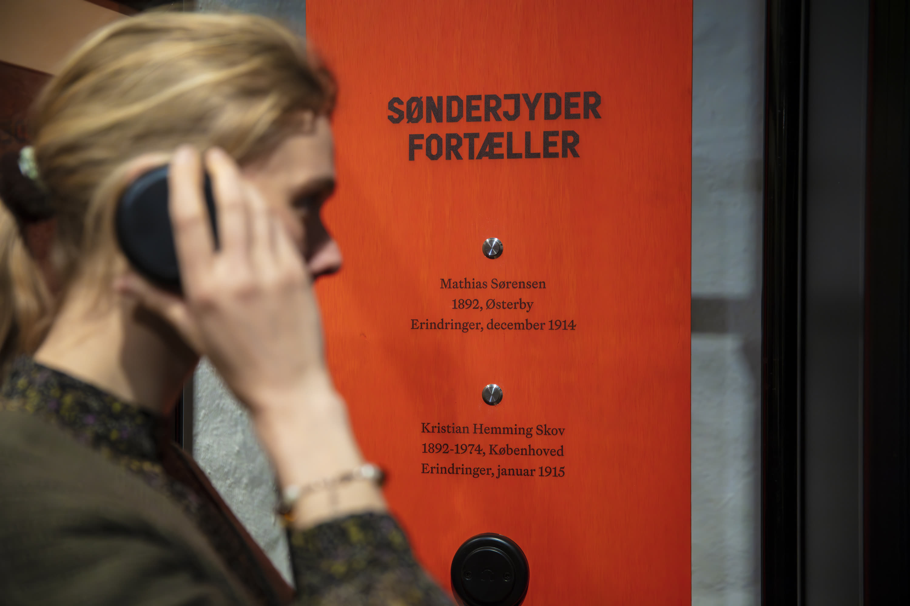 A guest with a field telephone to the ear