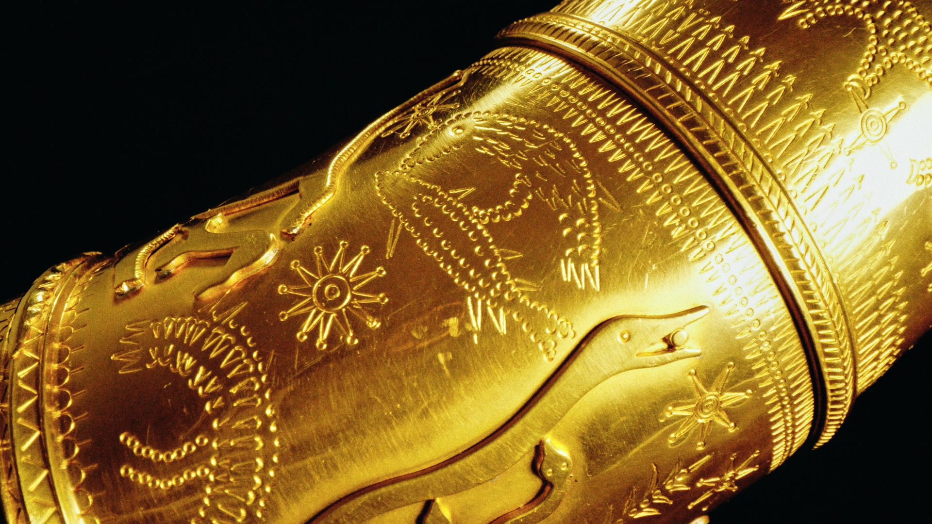 Figures and a sun on the gold, very close