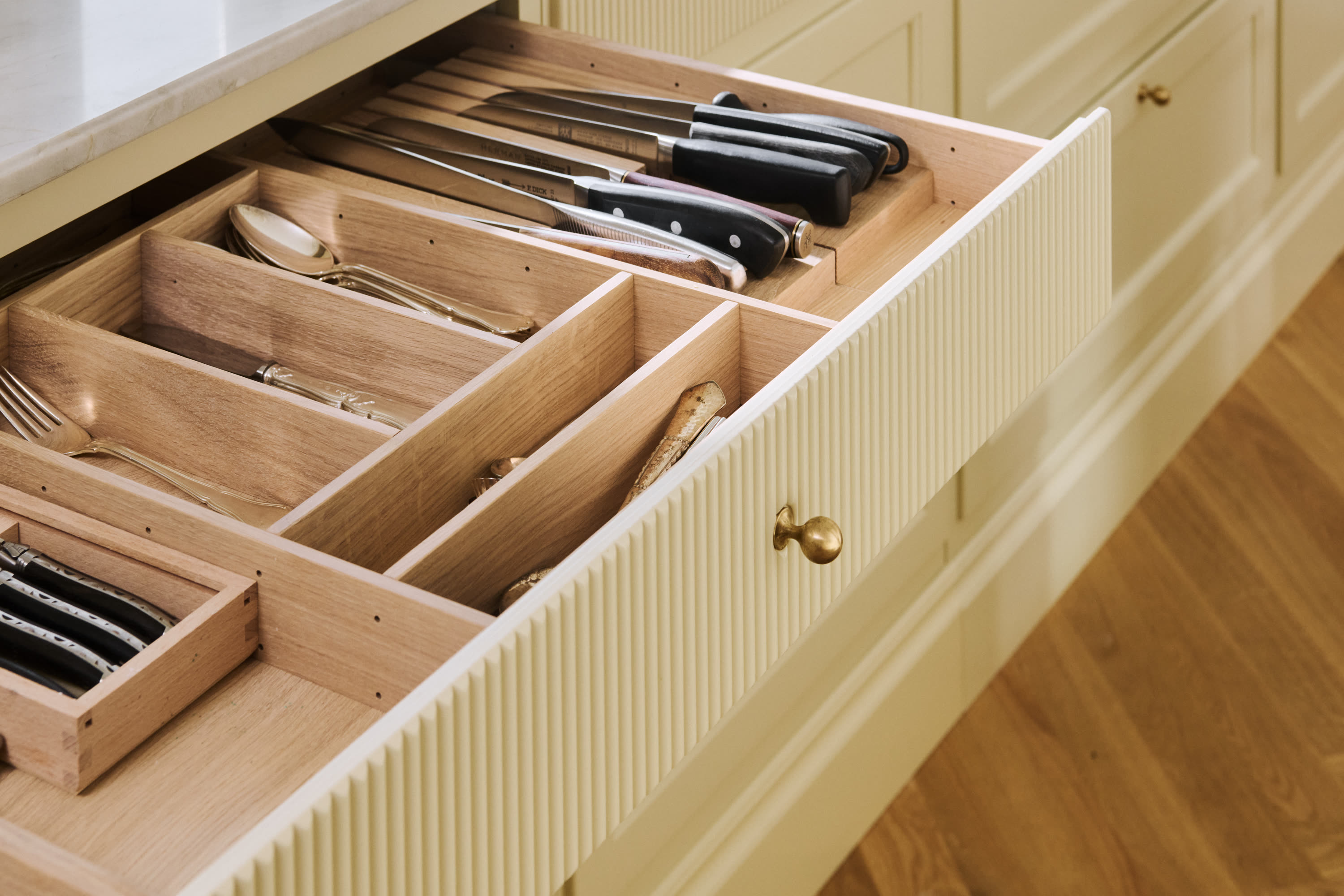 An open drawer with a fitted cutlery insert