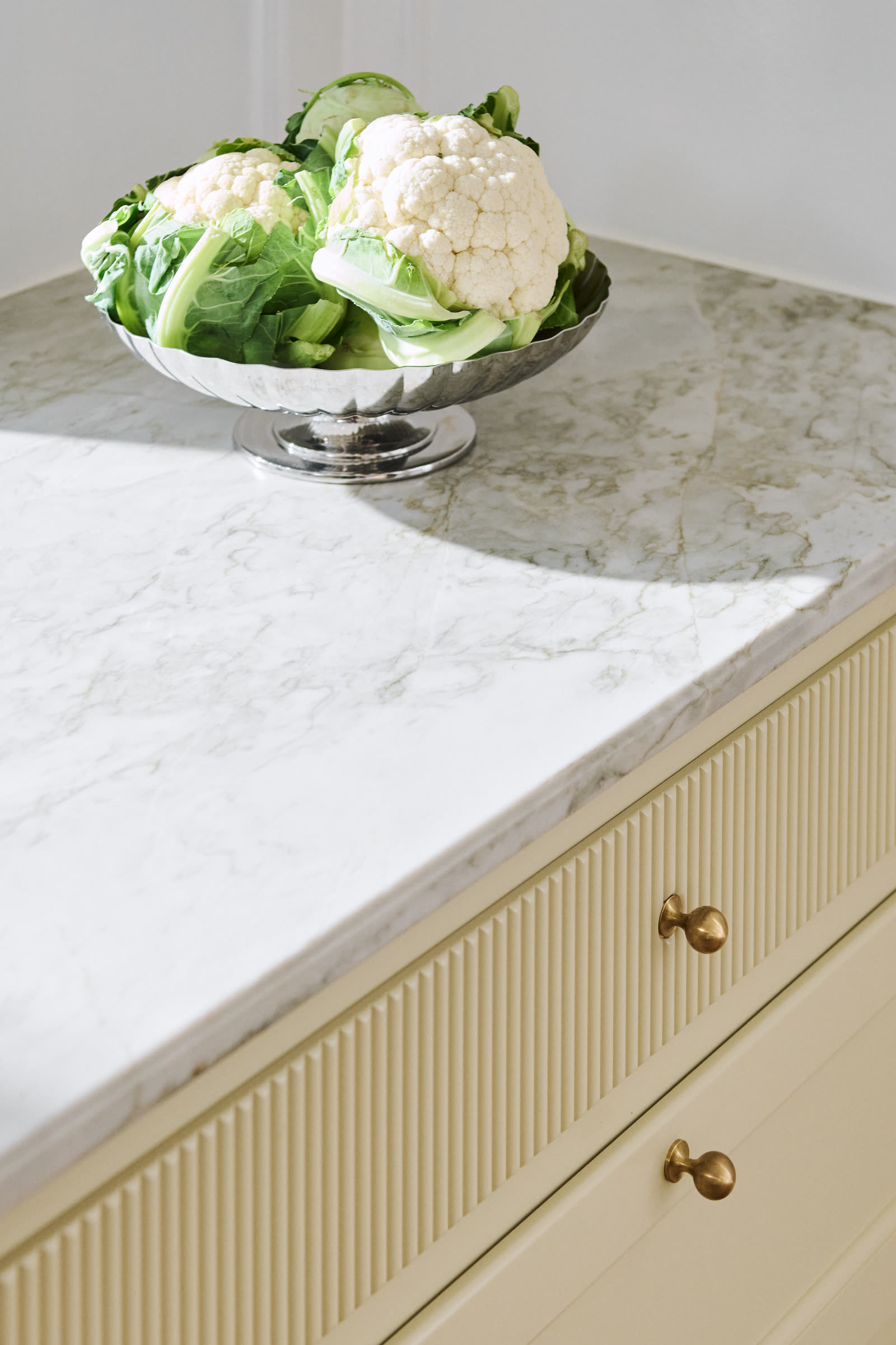 The stone worktop and fluted drawer