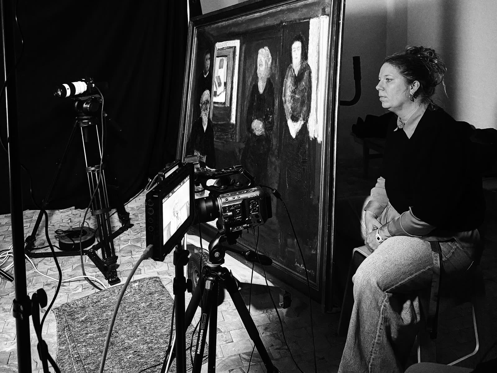 A participant next to a painting, with the camera in front