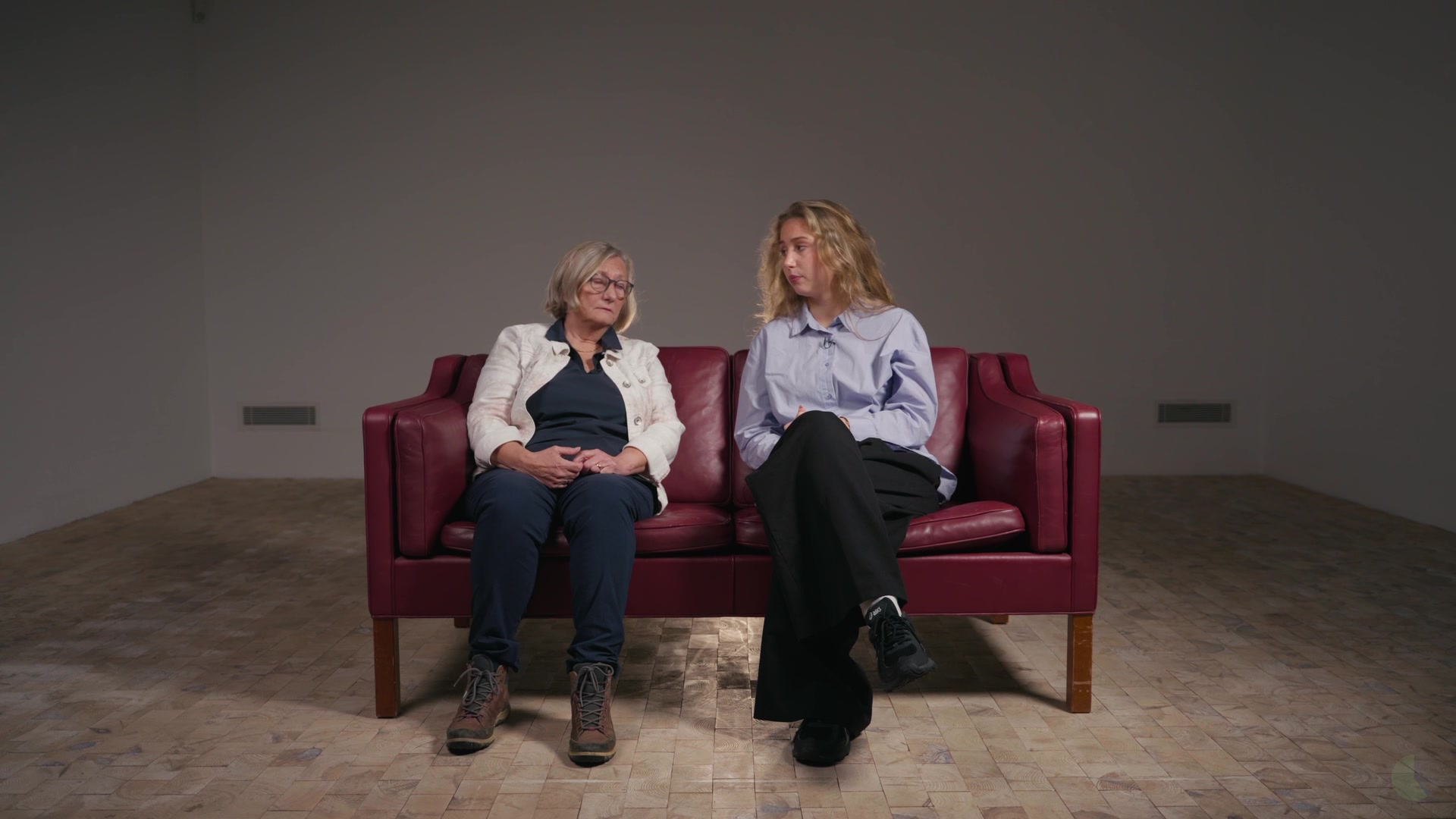 Two participants on the red sofa