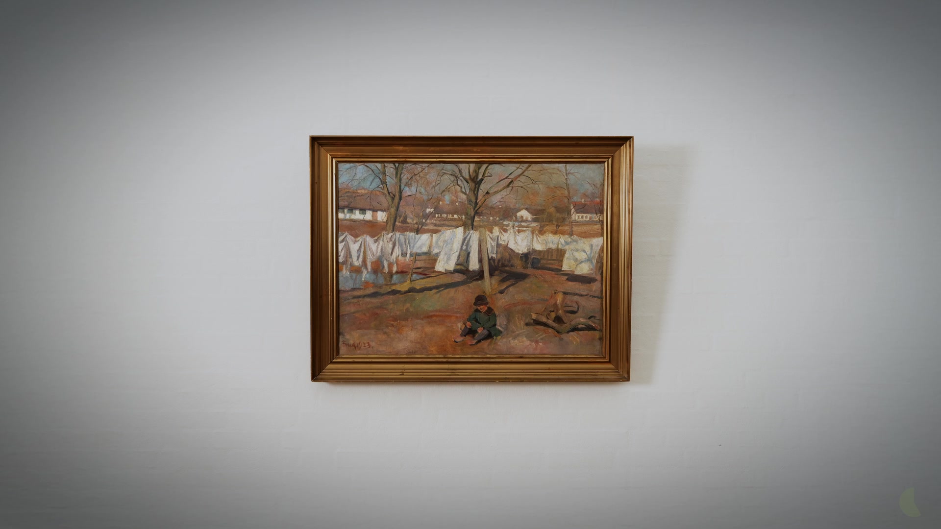 A landscape painting on the wall of the studio
