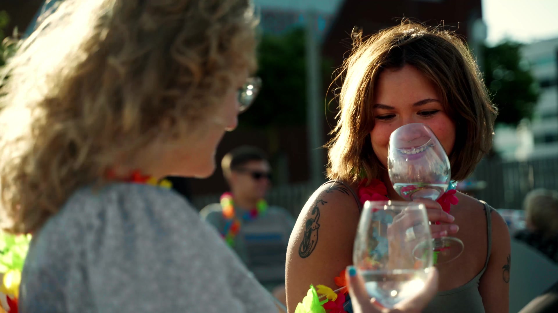 Friends with flower garlands and glasses of wine